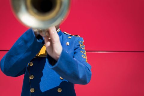 Marching Band Member Playing Trumpet in Ceremonial Uniform