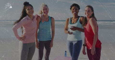 Four women enjoying beach workout and friendship in colorful activewear