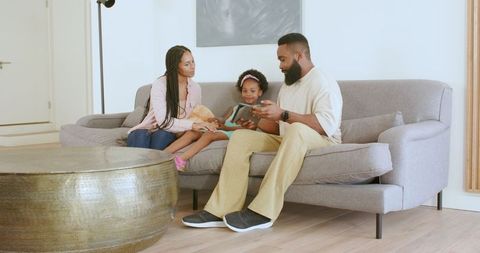 Happy Family Sharing Quality Time on Sofa at Home