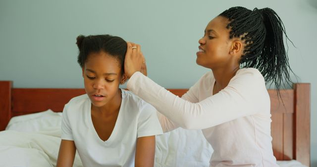 Mother Braiding Daughter's Hair on Bed in Cozy Bedroom - Download Free Stock Images Pikwizard.com