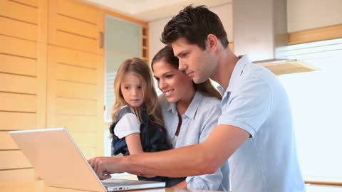Family Enjoying Quality Time Using Laptop at Home