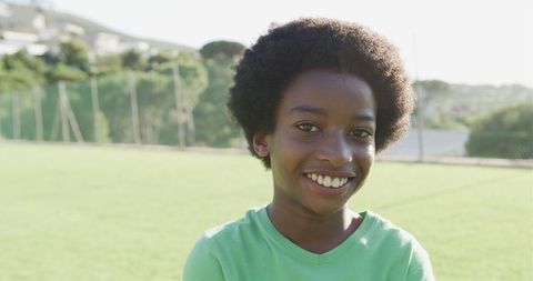 Young Boy Smiling Outdoors on Sunny Day in Park