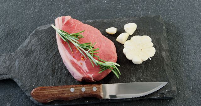 Raw Beef Steak with Rosemary and Garlic on Slate Board - Download Free Stock Images Pikwizard.com