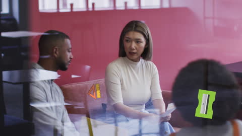 Diverse Team Collaborating with Digital Graphics in Modern Office