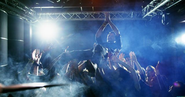 Energetic Crowd Surfing at Live Music Concert with Blue Lighting - Download Free Stock Images Pikwizard.com