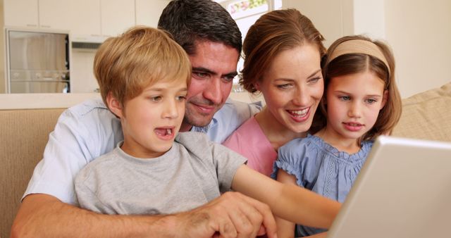 Happy Young Family Using Laptop Together On Couch In Living Room - Download Free Stock Images Pikwizard.com