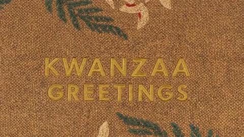Embossed gold KWANZAA GREETINGS shimmering on woven burlap with botanical accents