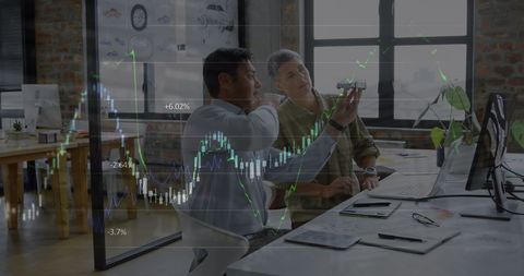 Financial analysts examining data charts in modern office
