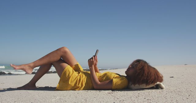 Young woman relaxing on the beach using smartphone - Download Free Stock Images Pikwizard.com