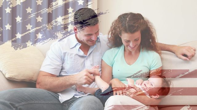 Young Caucasian parents cheerfully playing with their baby in a cozy living room, featuring an overlay of the United States flag. This heartwarming scene captures themes of family, love, and national pride, ideal for uses in parenting resources, patriotic campaigns, or as an illustration representing family bonds and American values.