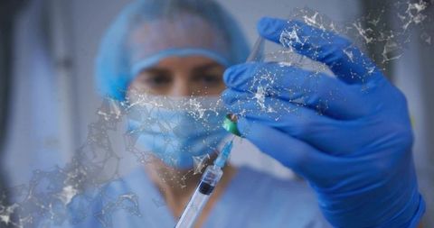 Nurse preparing vaccine syringe with vial and digital molecular network overlay for immunization