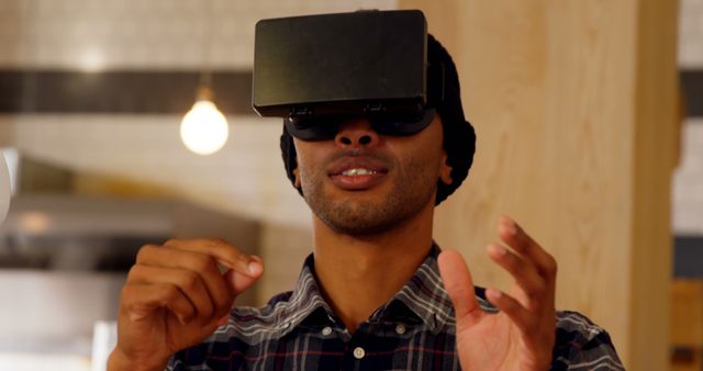 Young Man in Virtual Reality Headset Experiencing Simulation - Download Free Stock Images Pikwizard.com