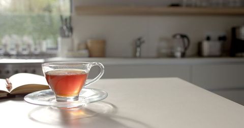 Morning Tea in Sunlit Kitchen with Open Book - Download Free Stock Images Pikwizard.com