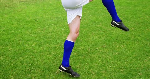 Soccer Player Performing Dynamic Kick on Green Field - Download Free Stock Images Pikwizard.com