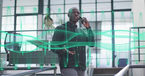 Business-casual man talking on smartphone and gesturing with green waveform overlay