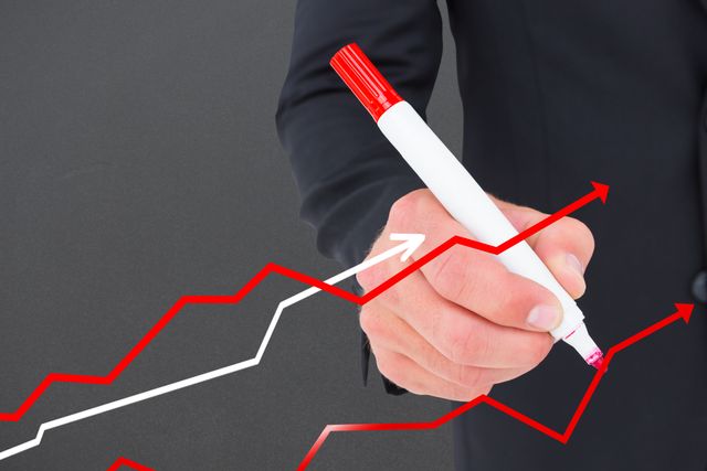 Businessman drawing upward trending financial graph with red marker. Ideal for use in presentations on business growth, financial analysis, market trends, and investment strategies. Useful for illustrating concepts of success, progress, and economic forecasting.