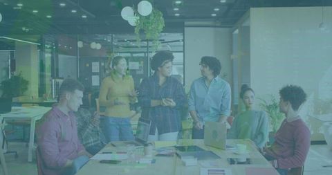 Creative Team Brainstorming Around Open-Plan Table with Leader in Mustard Sweater