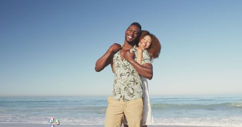 Joyful Couple Embracing on Sunny Beach with Social Media Icons