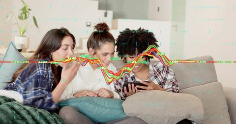 Three friends sharing smartphone on sofa, laughing and reacting with digital glitch overlay