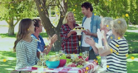 Joyous Family Gathering in Sunny Park with Picnic Table - Download Free Stock Images Pikwizard.com