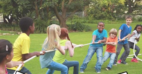 Kids Playing Tug of War in Park on Bright Sunny Day