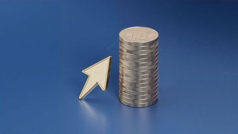 Stacked bitcoins online trading with gold upward arrow on blue background