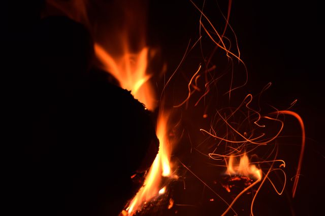 Close-Up of Flames with Floating Sparks at Night - Download Free Stock Photos Pikwizard.com