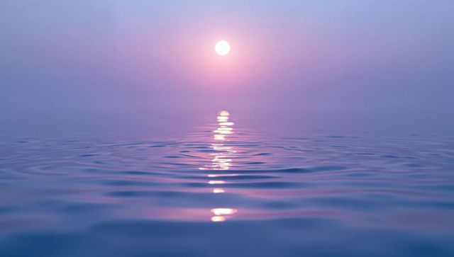 Sunset reflections on tranquil open water with pastel sky gradient