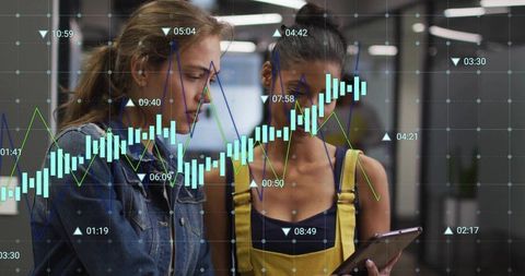 Two professionals analyzing interactive analytics on tablet with transparent data overlay