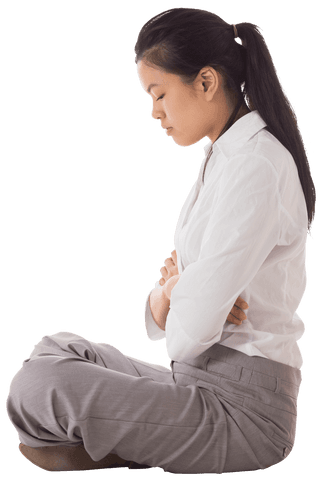 This image portrays an Asian businesswoman in professional attire sitting cross-legged with her arms folded. Her expression may convey contemplation or thoughtfulness, making this useful for illustrating calmness and reflection in corporate or productivity contexts. Ideal for career newsletters, self-improvement blogs, or imagery related to focus and introspection in professional settings.