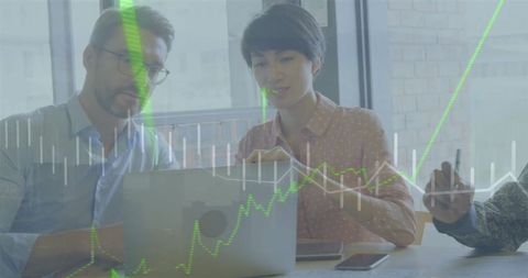 Business Team Analyzing Growth Charts on Laptop