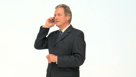 Senior Businessman Talking on Smartphone in Suit