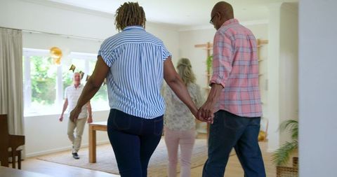 Senior Friends Warmly Greeting in Cozy Home Setting