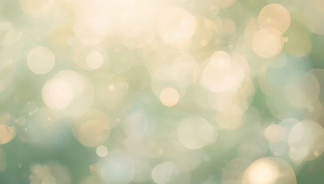Glowing pastel bokeh background shimmering with soft light orbs and dreamy halo effects