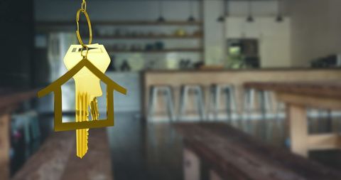 Golden house keys in trendy bar interior representing real estate welcome