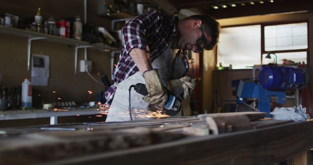 Man Grinding Metal in Workshop with Protective Gear - Download Free Stock Images Pikwizard.com