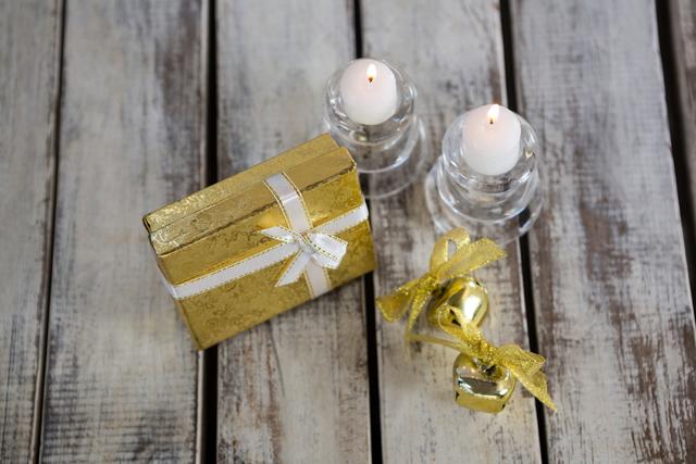 Festive Christmas Gift with Candles on Wooden Plank - Download Free Stock Photos Pikwizard.com