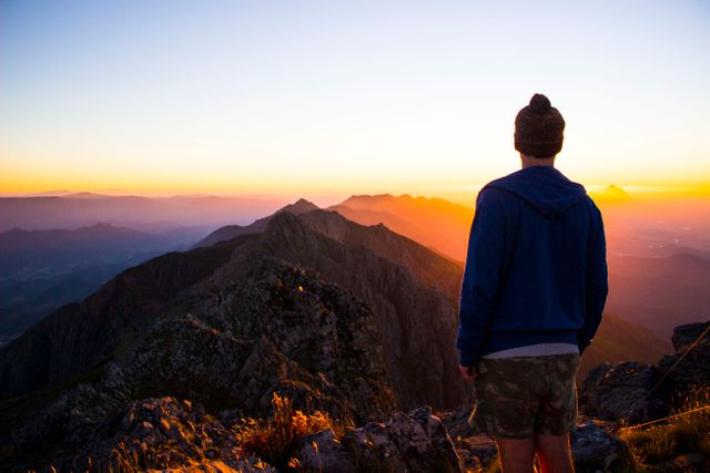 Hiker Admiring Mountain Sunset from Peak - Download Free Stock Photos Pikwizard.com
