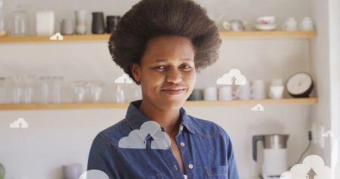 Smiling african american woman with digital cloud icons