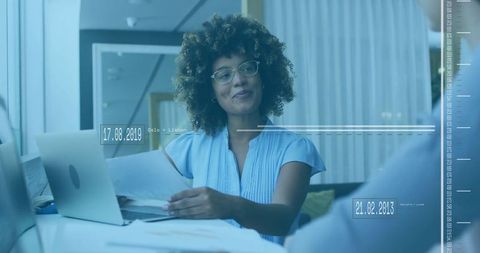 Smiling Woman in Office Collaborating at Introduction Meeting Table