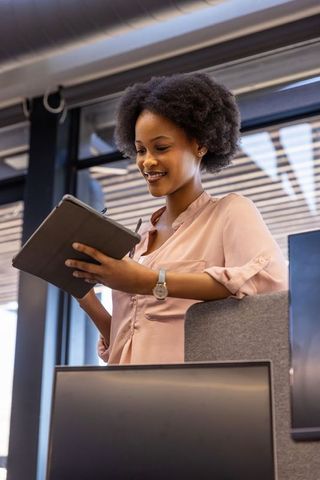 Businesswoman using digital tablet achieving success