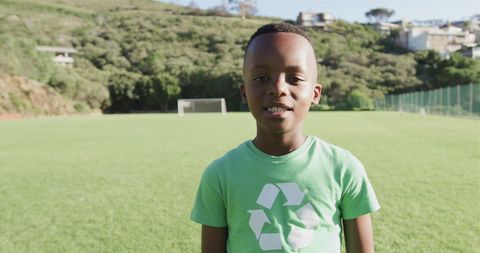 Boy in Recycling T-shirt on Soccer Field Outdoors Embracing Sustainability