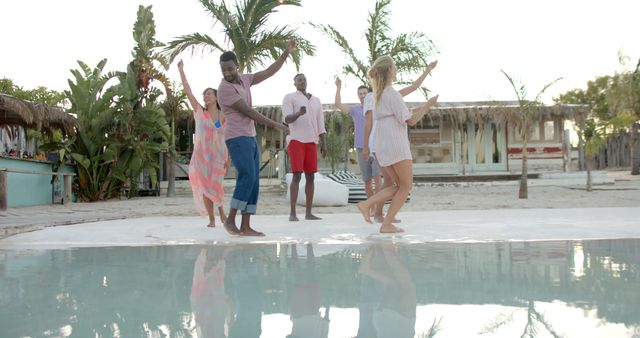 Group of Friends Dancing Joyfully by Tropical Poolside - Download Free Stock Images Pikwizard.com