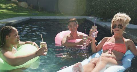 Friends Relaxing on Floaties in Summer Outdoor Pool - Download Free Stock Images Pikwizard.com