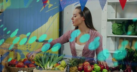 Market vendor interacting with augmented-reality projections over fresh produce display