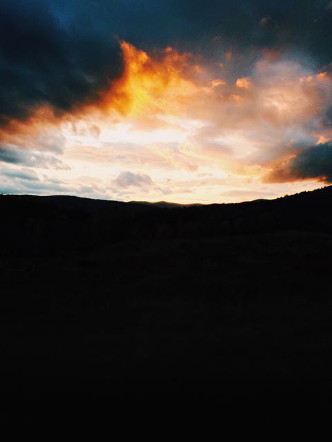 Dramatic Sunset with Fiery Clouds Over Hills and Mountains - Download Free Stock Photos Pikwizard.com