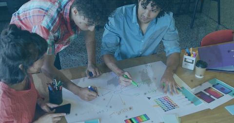 Creative Team Collaborating on Design Project with Markers and Charts