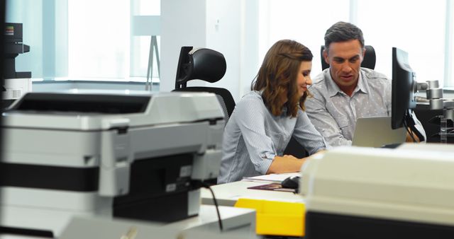 Co-workers Collaborating at Desk in Modern Office - Download Free Stock Images Pikwizard.com