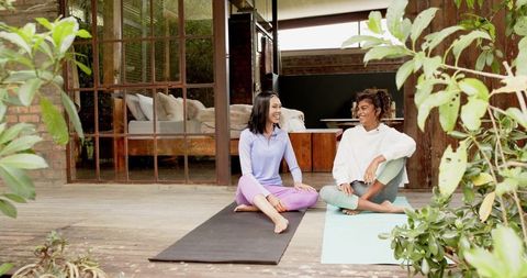Diverse Friends Enjoying Mindful Relaxation on Outdoor Yoga Deck