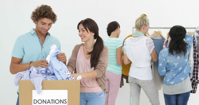 Volunteers Sorting Clothes for Donation in Community Center - Download Free Stock Images Pikwizard.com